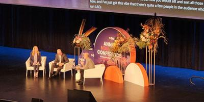 3 People on a stage as part of the panel at the DSC conference