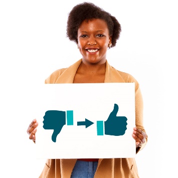 A woman holding a poster showing a thumbs down, and an arrow pointing to a thumbs up.